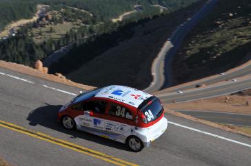 2012 PPIHC Practice Day Two.An essentially stock version of the electric-powered 2012 Mitsubishi i, driven by International off-road series race-winning driver Beccy Gordon, in a practice run in the middle section of the 2012 Pikes Peak International Hill Climb.