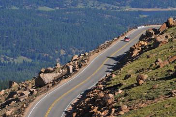 2012 PPIHC Practice Day Two.An essentially stock version of the electric-powered 2012 Mitsubishi i, driven by International off-road series race-winning driver Beccy Gordon, in a practice run in the middle section of the 2012 Pikes Peak International Hill Climb.